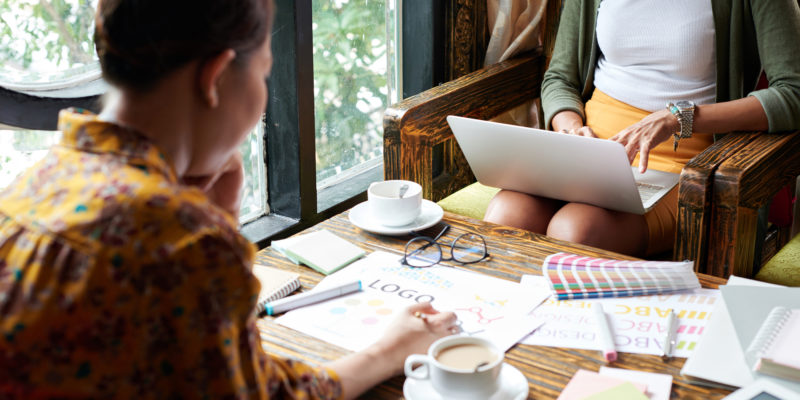 Women drinking coffee working